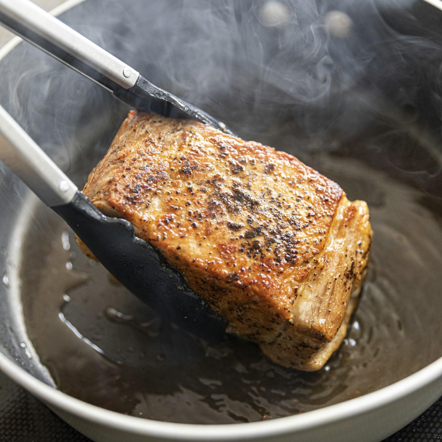 Community members working together in a contemporary kitchen, exchanging recipes and techniques